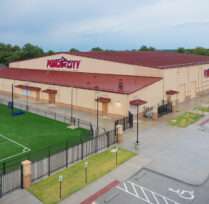 Side aerial view of building and soccer field