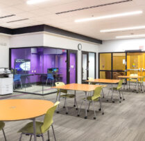 Study area with desks, chairs, and small meeting room