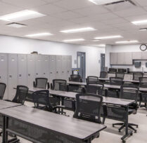 Training and meeting room with long tables and chairs