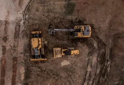 Photo of three tractors in a construction zone
