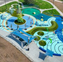 Aerial view of water park with blue equipment and trees