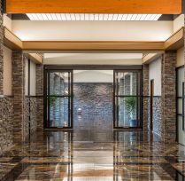 Main entryway with glass doors and brick columns