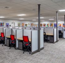 Office area with cubicles and art on the wall