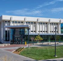 Exterior of white building with windows along the side
