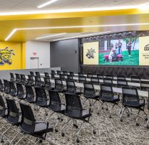 Auditorium with many chairs and large screen