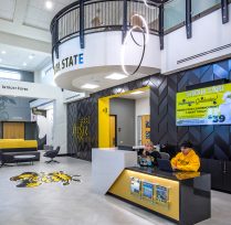 Left of entrance with welcome desk and second floor balcony