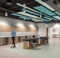 Walkway area with blue light fixtures and tables