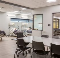 Healthcare classroom with hospital bed and chairs