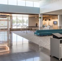 Interior front entrance with long couches and check in desk