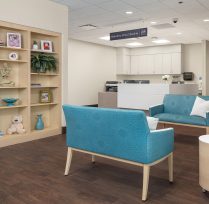 Waiting area with chairs and bookcase