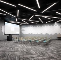 Large meeting room with many chairs and large screen in front