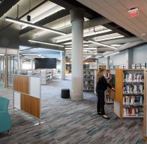 Woman next to bookshelf