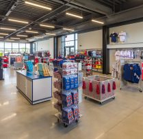 Inside of merchandise store with racks of clothes