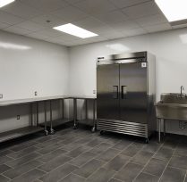 Back area kitchen with large fridge and countertops
