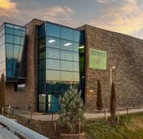 Exterior of brick building and large glass windows