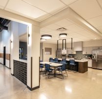 Kitchen area with tables, chairs, large counter space