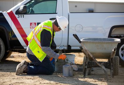 PEC technician testing concrete next to truck