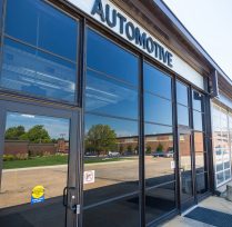 Exterior front of building with door and sign