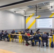 Classroom with long tables and presentation screen