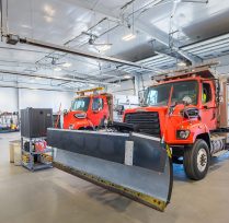 Close up of snow trucks in the large garage area
