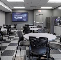 Break room with round tables, chairs, and counter area
