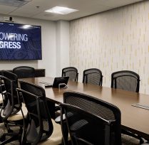 Conference room with table, chairs, and tv screen