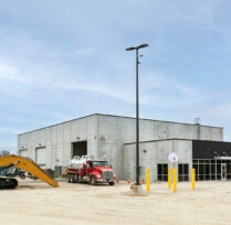 Exterior concrete building with machines out front