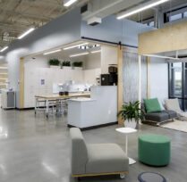 Main hallway area with sofas and kitchen area