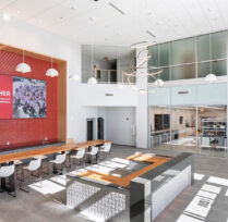 Front lobby with red wall, tables, and chairs