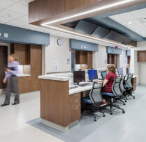 Nurse sitting at computer in reception area